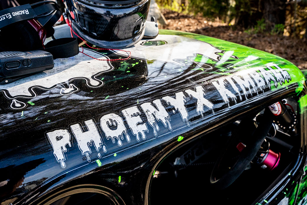Phoenyx's car, covered in neon green flames, is hard to miss!