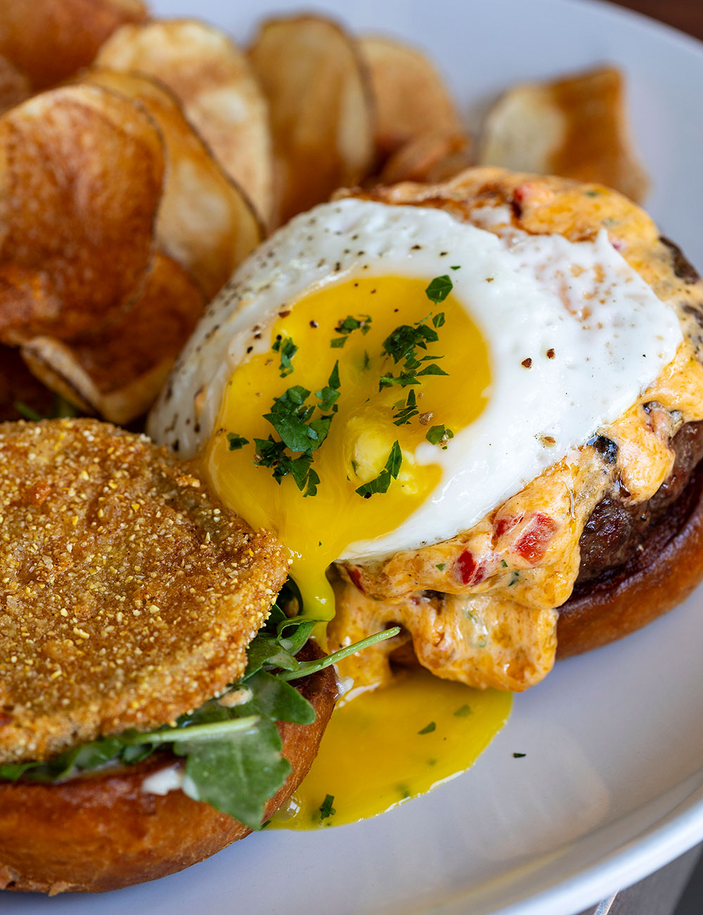 Topped with a fried green tomato, a runny egg, and pimento cheese, the Brunch Burger is one of Hummingbird's heftier brunch offerings.
