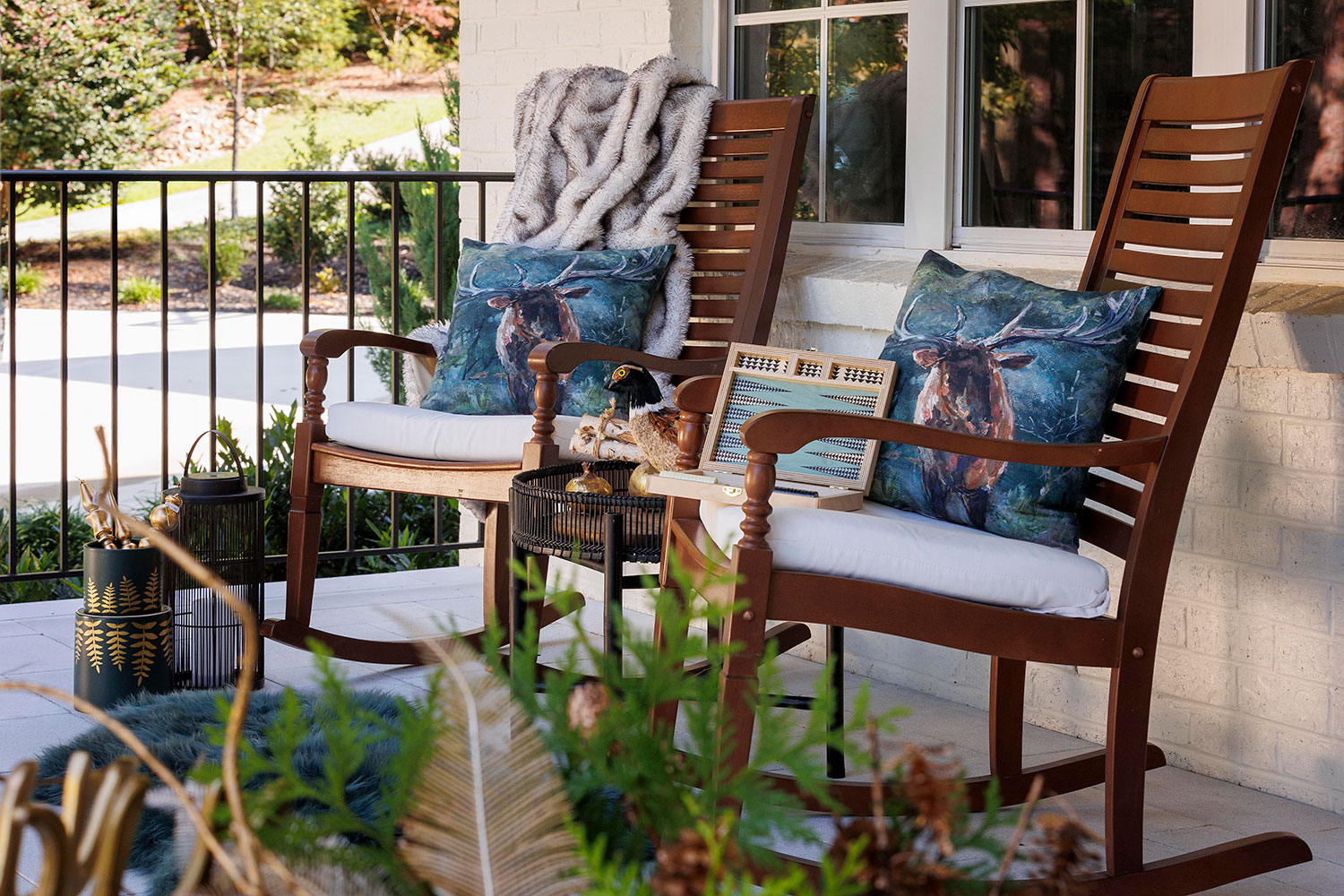 COZY UP WITH AN ENCHANTING PILLOW: Pillows enhance the eye-catching allure of porch décor while also adding cozy vibes. Embrace the forest trend by showcasing deer or other animal motifs on your pillows.