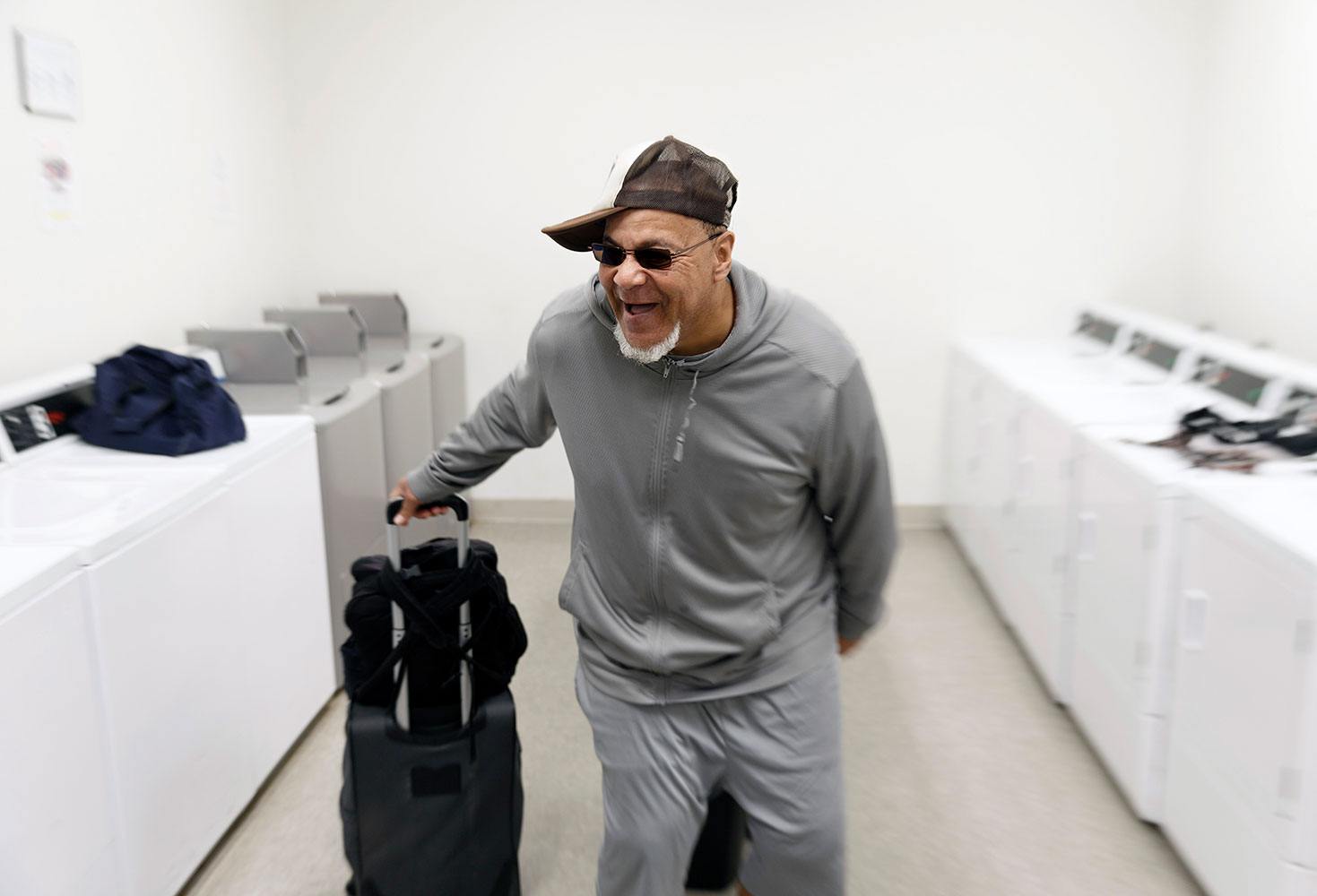 Oak City Cares guest Mr. Jenkins leaves the laundry facility with clean clothes — and a smile.