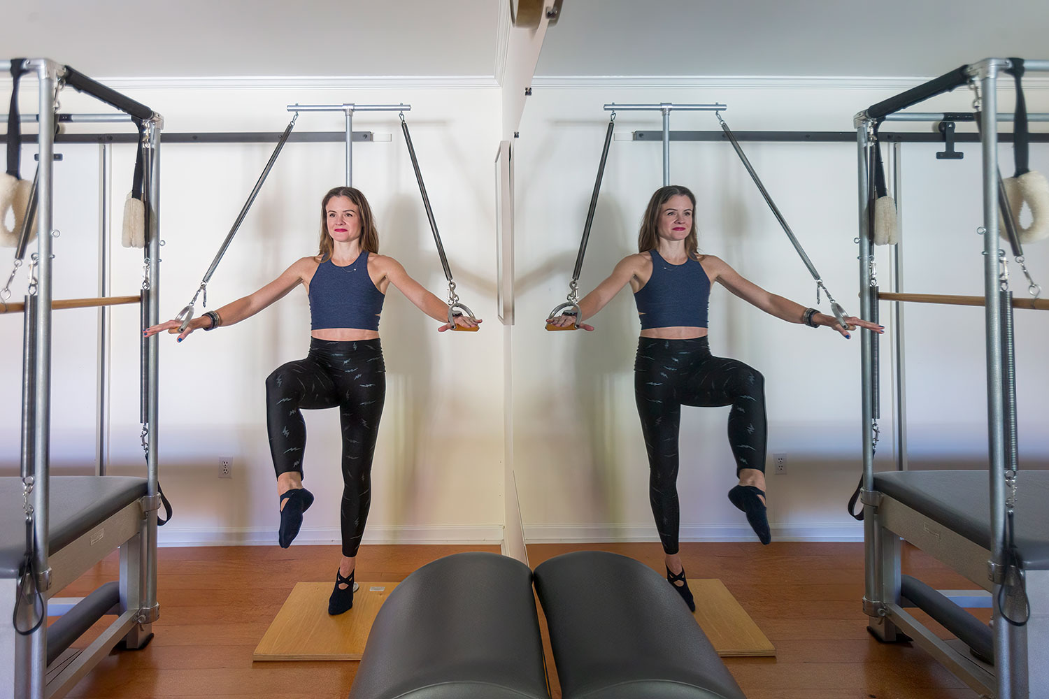 Luiza Barteldes Farinha, owner of Pilates of Luiza, gets a full-body workout with the Standing Arm Spring.